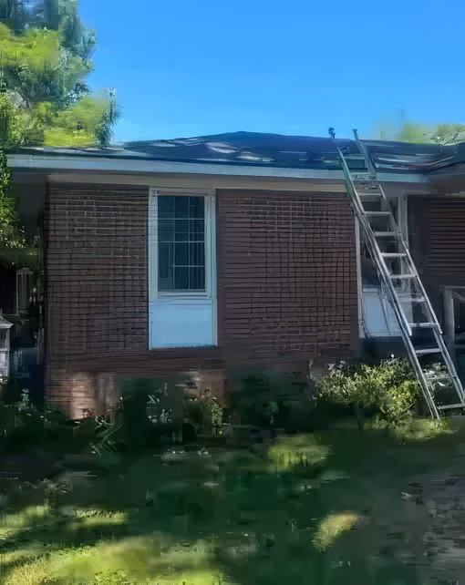 The same corner of the house with the roof fully repaired