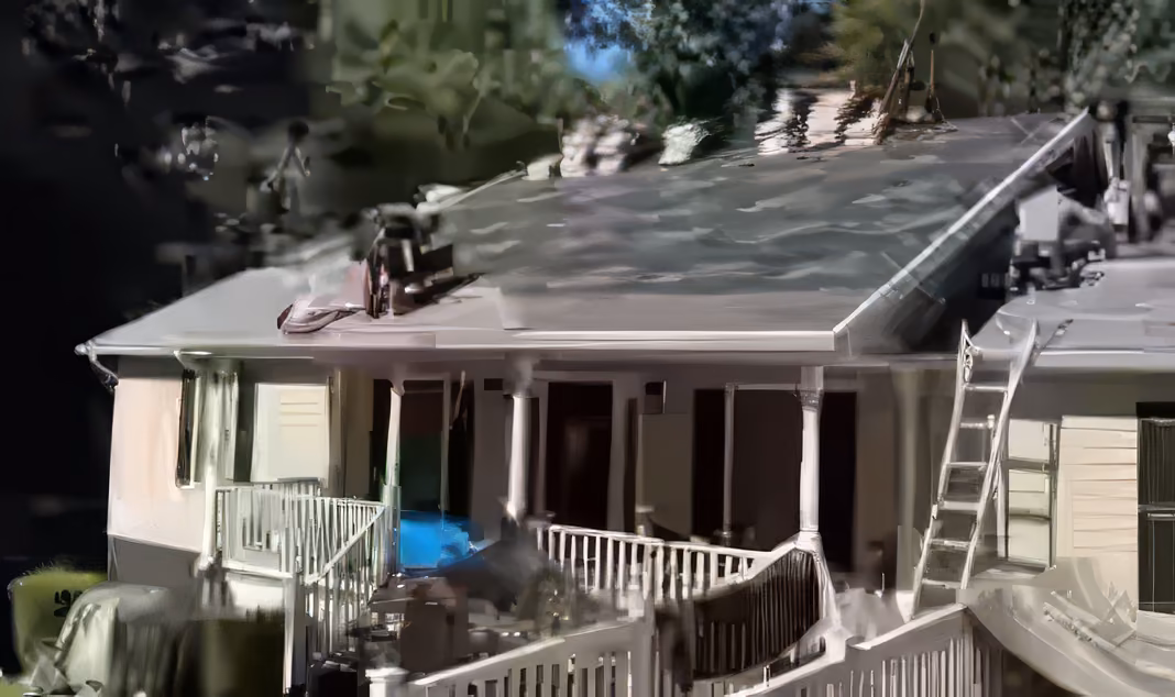 Crew installing new shingles during a full roof replacement