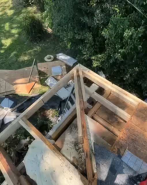 New roof framing being built on a damaged section of roof